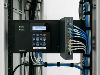 Modern network switch and alarm panel with IP connectivity; representing the transition from telephone line to IP-based alarm monitoring