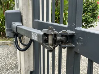 Singapore landed property swing gate with motor arm installation; gate weight and hinge condition are critical to motor longevity