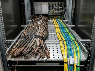 Old copper telephone cables alongside modern fibre optic cables; representing the telecommunications infrastructure transition that forced alarm systems to move from PSTN to IP