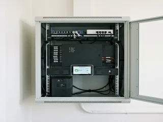 Modern integrated security system showing alarm panel, touchscreen keypad and network switch; representing the complexity of current installations